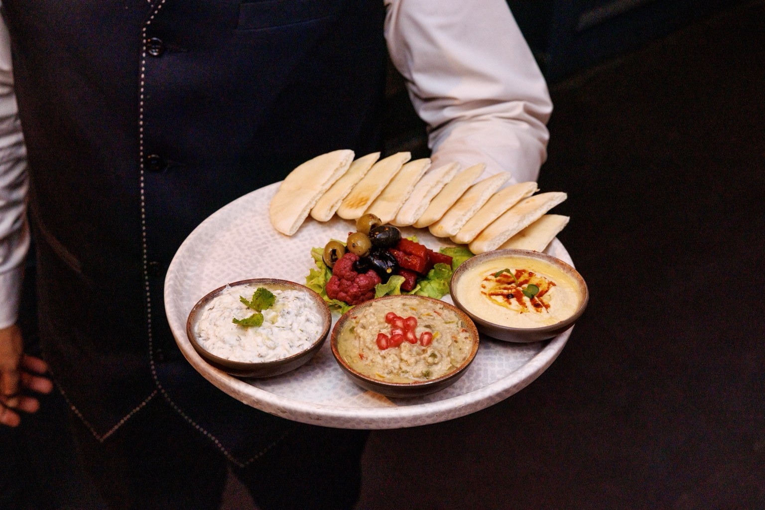 A platter of dips and breads served at Orae